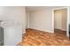 A brightly lit kitchen with laminate flooring, a washing machine, and white appliances at 730 Marble St, Charlotte, NC 28208