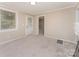 Neutrally decorated living room with fresh carpet and natural light at 730 Marble St, Charlotte, NC 28208