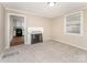 Bright living room with fireplace, carpet, and view of kitchen at 730 Marble St, Charlotte, NC 28208