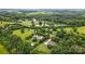 A picturesque neighborhood with lush trees and landscaping surrounding beautiful homes and ponds at 803 Freeman Rd, Concord, NC 28025