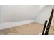 A view of an attic space with tan carpeting and white painted walls at 803 Freeman Rd, Concord, NC 28025