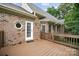 Lovely brick home exterior with walkout deck, white door, and octagon window at 803 Freeman Rd, Concord, NC 28025