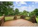 Relaxing wooden deck with brown railing and beautiful landscaping view at 803 Freeman Rd, Concord, NC 28025