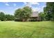Beautiful backyard featuring a lush lawn, mature trees, and a large outdoor area at 803 Freeman Rd, Concord, NC 28025