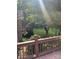 View from deck of backyard featuring flowering bushes and mature shade trees at 803 Freeman Rd, Concord, NC 28025