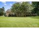 A gorgeous home with spacious green lawn, mature trees, and lovely walkout deck at 803 Freeman Rd, Concord, NC 28025