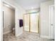 Bright bathroom featuring a glass-enclosed shower, toilet, and linen closet for convenience and style at 803 Freeman Rd, Concord, NC 28025