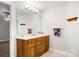 Well-lit bathroom with a large mirror, wood vanity, and decorative towel rack for a cozy feel at 803 Freeman Rd, Concord, NC 28025