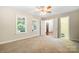 Spacious bedroom featuring neutral walls, plush carpet, and a ceiling fan, offering comfort and style at 803 Freeman Rd, Concord, NC 28025