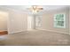 Spacious bedroom featuring neutral walls, plush carpet, and a ceiling fan, offering comfort and style at 803 Freeman Rd, Concord, NC 28025