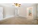 Spacious carpeted bedroom with a ceiling fan and multiple doorways at 803 Freeman Rd, Concord, NC 28025