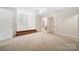 Bright bedroom with neutral carpet, staircase platform, and open doorway to bath at 803 Freeman Rd, Concord, NC 28025