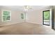 Bright bedroom with neutral carpet, natural light from windows, and access to the deck at 803 Freeman Rd, Concord, NC 28025