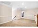 Upstairs bonus room with neutral walls, plush carpet, and ample natural light, perfect for various activities at 803 Freeman Rd, Concord, NC 28025