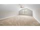 A large bonus room with neutral carpet, sloped ceilings, and a ceiling fan at 803 Freeman Rd, Concord, NC 28025