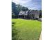 Beautiful two-story brick home featuring manicured lawn, lush landscaping, and an attached garage at 803 Freeman Rd, Concord, NC 28025