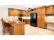 Traditional kitchen featuring wood cabinets, modern appliances, and an eat-in bar area at 803 Freeman Rd, Concord, NC 28025