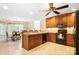 Charming kitchen with wood cabinets, black appliances, and an adjacent dining area at 803 Freeman Rd, Concord, NC 28025