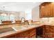 Close up of traditional kitchen sink with wood cabinets and view to dining area at 803 Freeman Rd, Concord, NC 28025