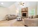 Inviting living room features a brick fireplace, neutral carpet, and comfortable seating at 803 Freeman Rd, Concord, NC 28025
