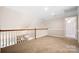 Upstairs loft area with neutral walls, plush carpet, and natural light, ideal for relaxation or hobbies at 803 Freeman Rd, Concord, NC 28025