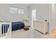 bedroom with a crib, comfortable chair, and wood flooring detail at 933 E 36Th St, Charlotte, NC 28205