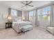 Inviting bedroom filled with natural light, a ceiling fan, and a cozy seating area at 933 E 36Th St, Charlotte, NC 28205
