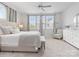 Bright bedroom featuring a queen bed, neutral tones, and plenty of natural light from the windows at 933 E 36Th St, Charlotte, NC 28205