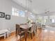 Spacious dining area with hardwood floors, a wooden table, and an open-concept layout at 933 E 36Th St, Charlotte, NC 28205