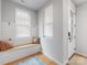 Bright and airy foyer featuring a built-in bench, natural light, and hardwood floors, creating an inviting entrance at 933 E 36Th St, Charlotte, NC 28205