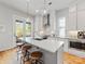 Bright kitchen features a center island with seating, modern appliances, and white cabinetry at 933 E 36Th St, Charlotte, NC 28205