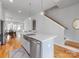 Kitchen island with stainless steel sink and dishwasher, featuring open layout and hardwood floors at 933 E 36Th St, Charlotte, NC 28205