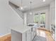 Kitchen island with stainless steel sink, with open access to French doors and exterior deck at 933 E 36Th St, Charlotte, NC 28205