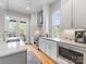 Bright kitchen featuring an island with seating, stainless steel appliances, and white cabinetry at 933 E 36Th St, Charlotte, NC 28205