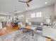 Open-concept living room with hardwood floors, a large rug, and comfortable seating arrangement at 933 E 36Th St, Charlotte, NC 28205