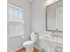 Well-lit powder room featuring a pedestal sink, a toilet, and a clean, modern design at 933 E 36Th St, Charlotte, NC 28205