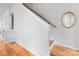 Clean staircase with hardwood steps and a modern railing, offering a smooth transition between floors at 933 E 36Th St, Charlotte, NC 28205