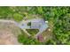 Aerial view of property with buildings and gravel drive, surrounded by grass and treed perimeter at 10016 Morgan Mill Rd, Monroe, NC 28110