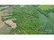 Aerial view of a property with farmland and densely wooded areas at 10016 Morgan Mill Rd, Monroe, NC 28110