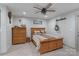 Neutral bedroom with wood trim, a ceiling fan, and a wooden bed frame at 10016 Morgan Mill Rd, Monroe, NC 28110