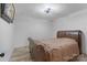 Cozy bedroom with hardwood floors and a traditional bed with a decorative headboard and bedding at 10016 Morgan Mill Rd, Monroe, NC 28110