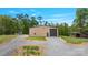 Exterior view of a metal building featuring a large garage door and gravel driveway at 10016 Morgan Mill Rd, Monroe, NC 28110