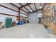 Large open garage with high ceilings, shelving, and storage at 10016 Morgan Mill Rd, Monroe, NC 28110