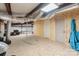 Second-story garage area with plywood flooring, ductwork, and doors leading to additional spaces at 10016 Morgan Mill Rd, Monroe, NC 28110