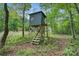 Elevated hunting stand surrounded by lush green trees and leafy ground at 10016 Morgan Mill Rd, Monroe, NC 28110