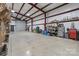 Spacious metal building interior, featuring high ceilings, ample storage, and a large garage door at 10016 Morgan Mill Rd, Monroe, NC 28110