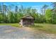 Rustic outbuilding featuring weathered wood and a gravel driveway at 10016 Morgan Mill Rd, Monroe, NC 28110