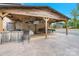 A covered outdoor kitchen with multiple grills, bar and entertainment area at 10016 Morgan Mill Rd, Monroe, NC 28110