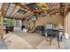 A covered outdoor kitchen with multiple grills, seating, and a TV for entertainment at 10016 Morgan Mill Rd, Monroe, NC 28110