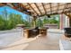 Outdoor patio with a rustic wooden bar overlooking a wooded backyard area with a storage shed at 10016 Morgan Mill Rd, Monroe, NC 28110